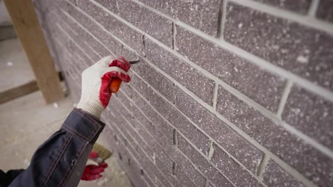 Grouting seams on the facade of the building with a trowel. Stock Footage 221346298