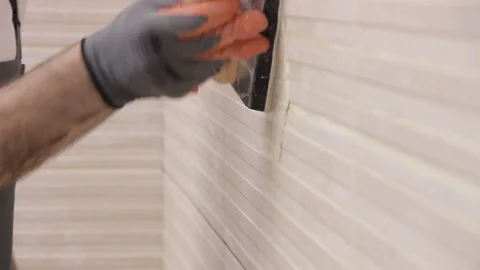 Grouting striped tiles Stock Footage 111865421