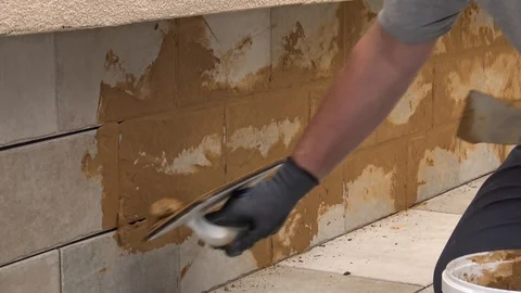 Grouting tiles with beige grout Stock Footage 111865885