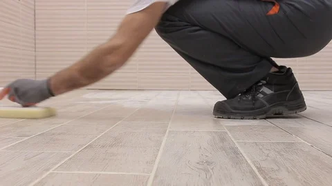 Grouting tiles on the floor in the bathroom Stock Footage 111865459