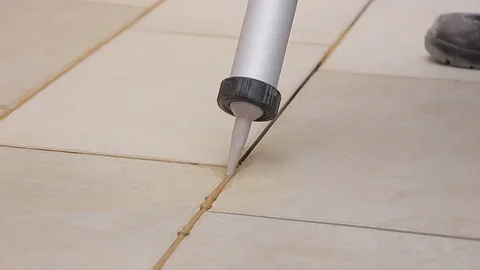 Grouting tiles with a gun Stock Footage 111865985