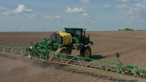 Growing cultivating vegetables. tractor pulls barrel with irrigation system Stock Footage 230701805