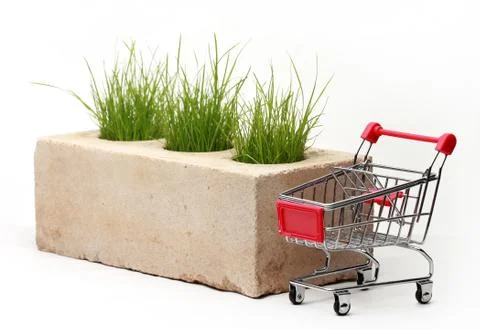 Growing grass made of bricks on a white background Stock Photos