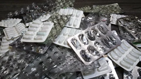 Growing pile empty medication pills blisters. Painkillers and other medicaments Stock Footage 297505234