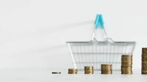 Growing stacks of coins representing increasingly expensive prices in front o Stock Footage 205280862