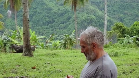 A grown man eats a banana. Video stock 137554760