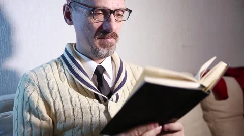 A grown man reading a book Stock Footage 60743975