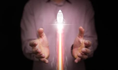 Growth concept. Hand with launching up rocket and fire trail, Growing succe.. Stock Photos