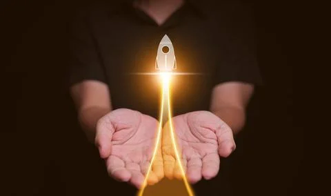 Growth concept. Hands with launching rocket. Growing success, startup break.. Stock Photos