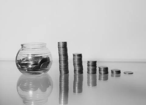 Growth graph from stack of coin and clear jar with thai baht coin Stock Photos