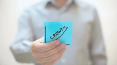 Growth. A man sticks a note on transparent screen Stock Footage 68088722