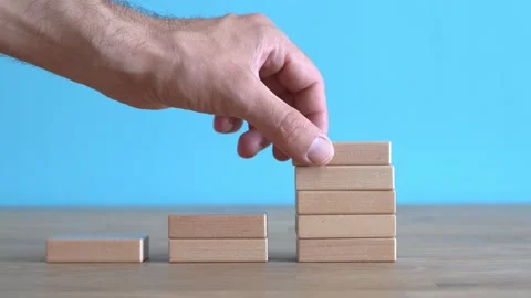 Growth, target, upskill concept. Growth of wooden cubes on a clean background Stock Footage 239985295