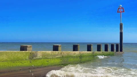 Groyne hit by waves Stock Footage 242208057