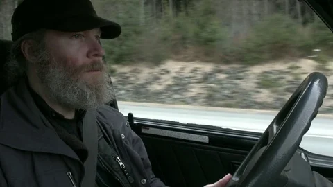 Grumpy Bearded Man Drives in Alaska Stock Footage 83945170