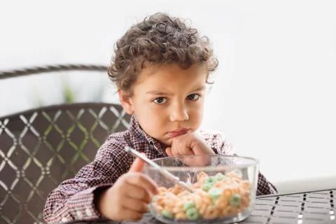 Grumpy child disappointed with his breakfast Stock Photos