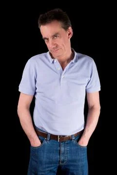 Grumpy frowning man with hands in pockets Stock Photos