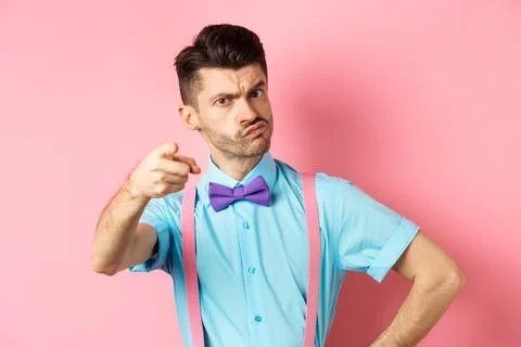 Grumpy guy in bow-tie and suspenders accusing you, its your fault gesture Stock Photos