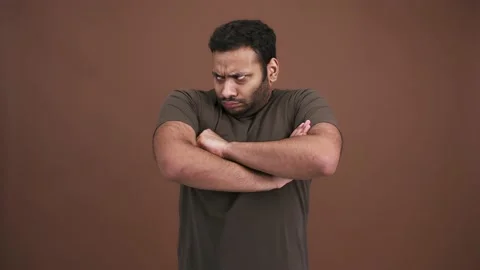 Grumpy indian man looking around and folding his arms, feeling sad and offended Stock Footage 145150870