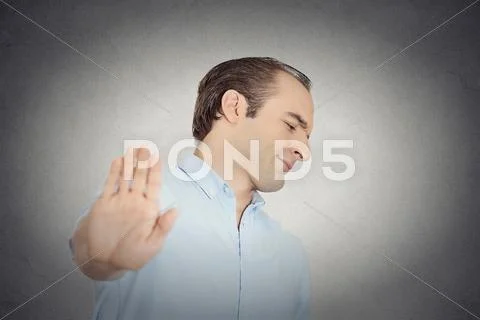 Grumpy man with bad attitude giving talk to hand gesture Stock Photos