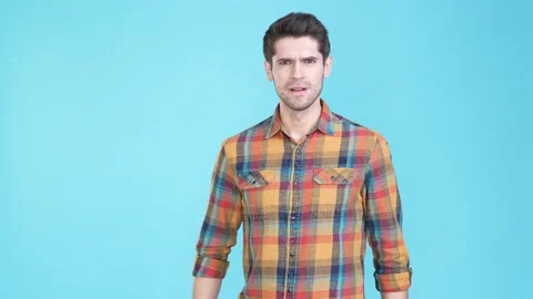 Grumpy moody guy cross arms have disagreement isolated blue color background Stock Footage 170130188