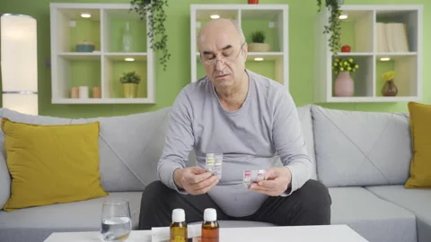 Grumpy old man using over-the-counter drugs by heart. Video stock 234145341