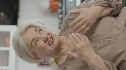Grumpy old woman sitting on sofa at home. Stock Footage 196151662