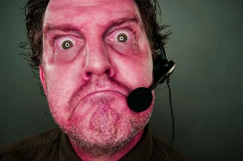 Grumpy Red Eyes and Face Customer Support Man with Headset 스톡 사진