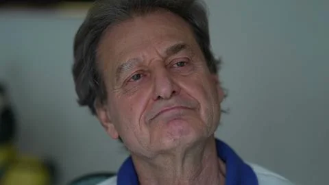 Grumpy senior man close-up face looking at camera with upset pensive expressi 스톡 사진