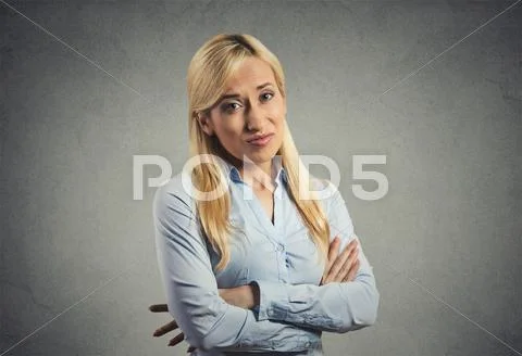 Grumpy skeptical blonde woman isolated on gray background Stock Photos