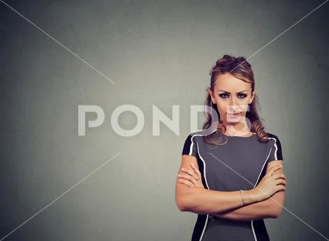Grumpy woman in dress looking serious Stock Photos