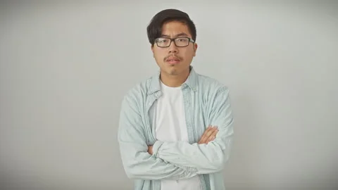 Grumpy young chinese guy with glasses, doubtful and upset, showing displeas.. Stock Footage 279913908