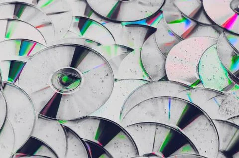 Grunge backdrop of old CD DVD compact optical disk storage medium with dust Stock Photos