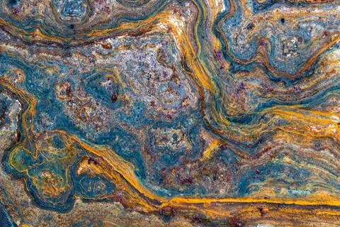 Grunge background: curly rust on an old metal surface, toning Stock Photos