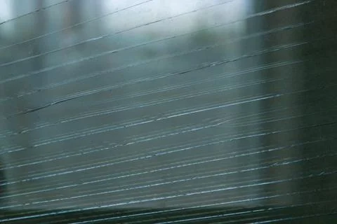 Grunge background: long parallel cracks on dirty glass Stock Photos