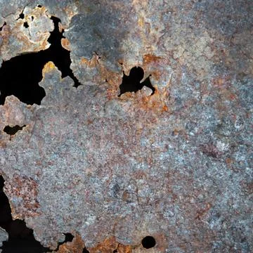 Grunge background: rust on an old painted metal surface, holes from through c Stock Photos