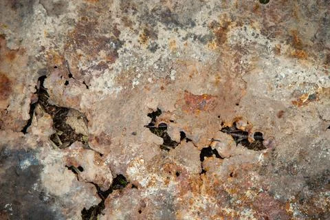 Grunge background: rust on an old painted metal surface, holes from through c Stock Photos