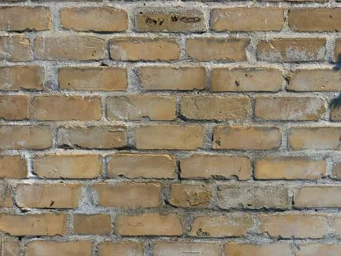 Grunge background of tiled bricks, soft colors. Closeup yellow brick wall Stock Photos