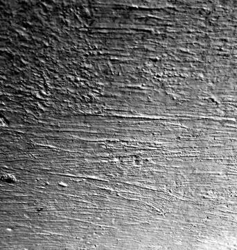 Grunge dark textured surface with horizontal scratches and grain Stock Photos