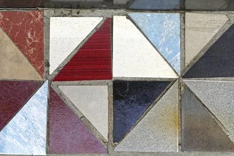 Grunge floor tiles made from triangular pieces Stock Photos