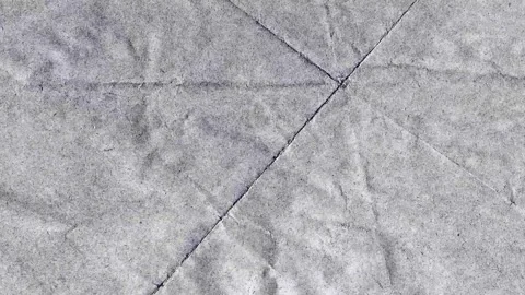 Grunge Paper Fold Texture with Diagonal Creases on Neutral Background Stock Footage 327968931