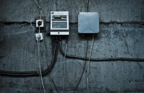 Grunge technological background with cables and devices on the wall Stock Photos