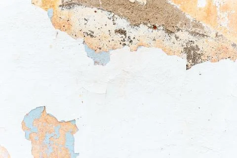 Grunge texture of ancient wall with white chipped stucco Stock Photos