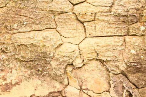 Grunge texture of cracked stone surface Stock Photos