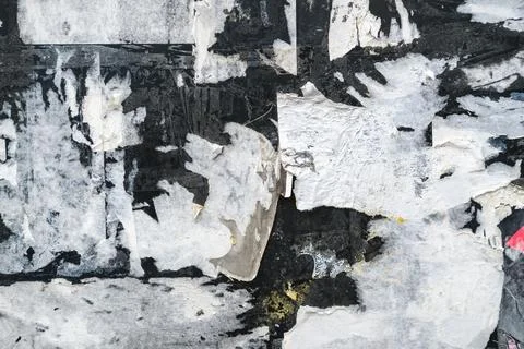Grunge texture of torn paper layers and worn posters on old wall with rough.. Stock Photos
