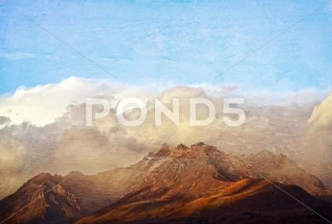 Grunge textured mountain range in the clouds Stock Photos