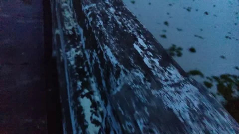 The grunge wall bridge wall against river water and the blue-toned night li.. Stock Footage 324904420