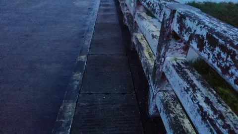 The grunge wall bridge wall against river water and the blue-toned night li.. Stock Footage 324904460
