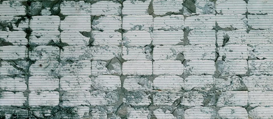 Grunge wall texture background with exposed white brick block grid pattern. Stock Photos