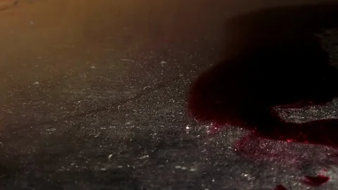 Grungy conceptual scene with blood like puddle and a droplet on the frame Stock Footage