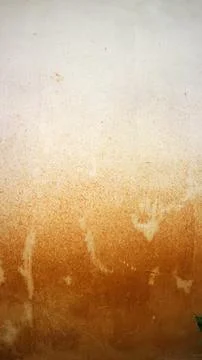 Grungy wall surface showing aged brown paint fading to white with textured .. Stock Photos
